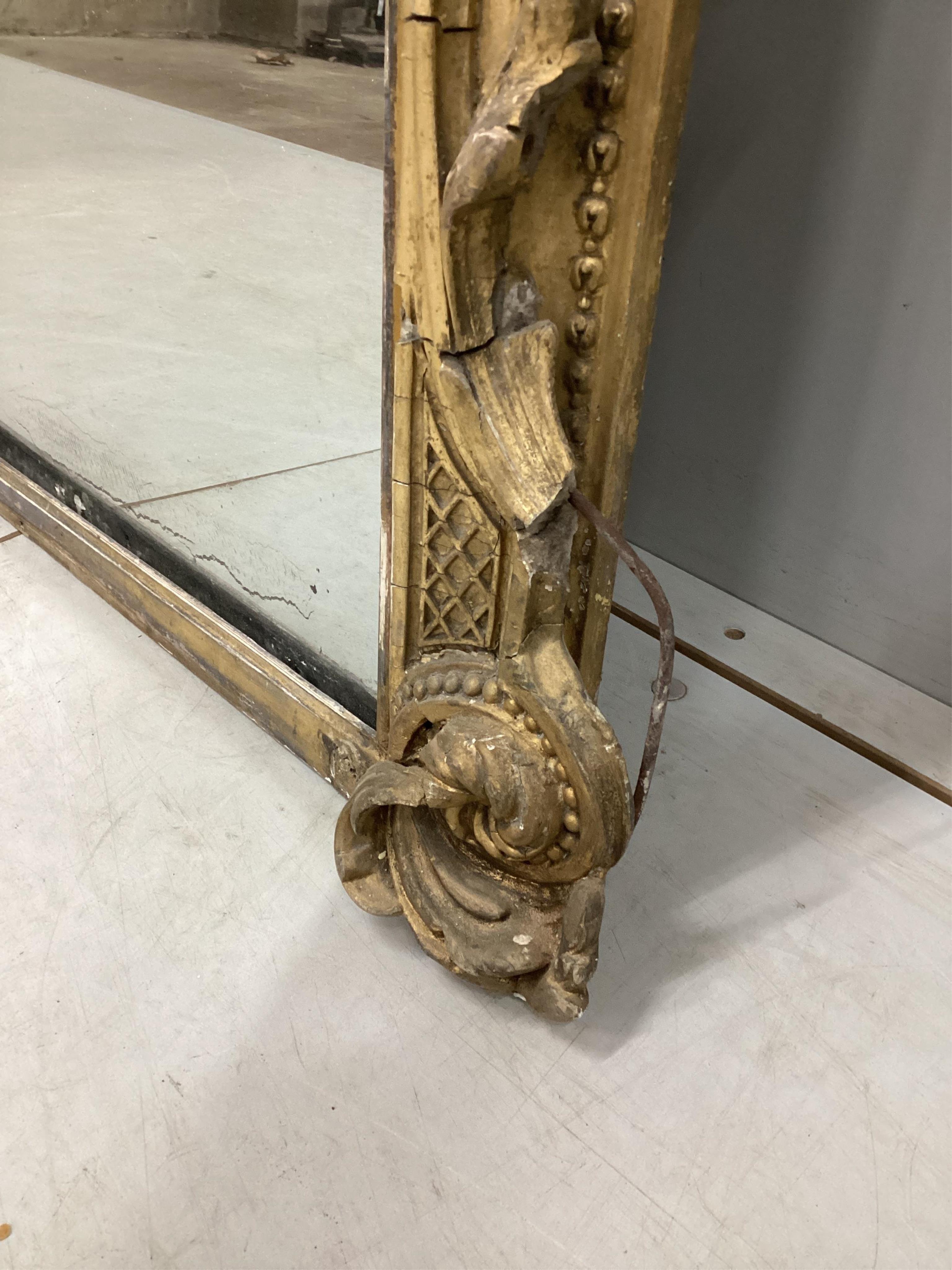 A Victorian giltwood and composition overmantel mirror with cartouche pediment, width 140cm, height 201cm. Condition - fair, three areas of lost gesso